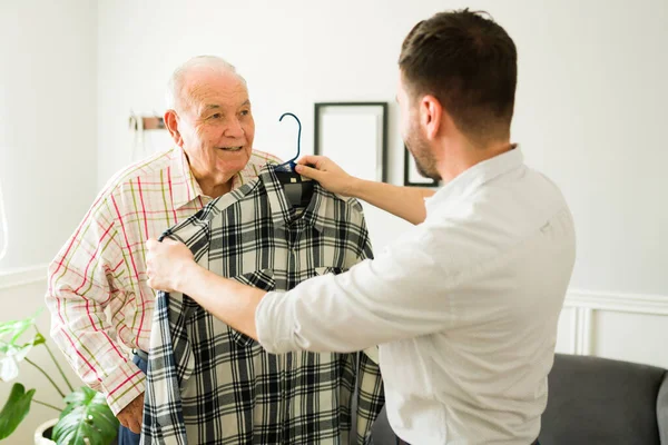Happy Young Man Giving Shirt New Clothes His Elderly Smiling — Stock Photo, Image