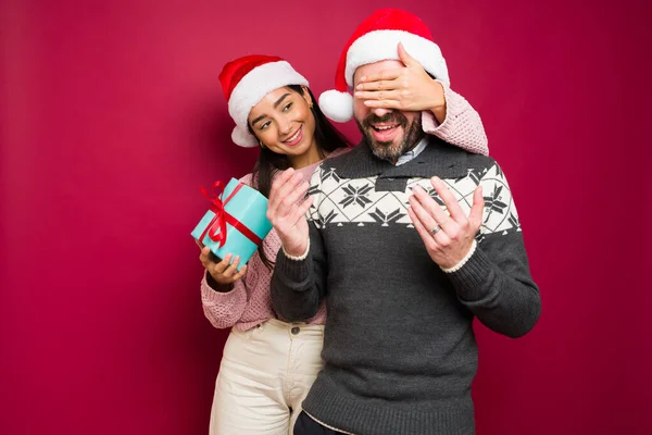 Attractive Young Woman Covering Eyes Happy Man Surprise Him Christmas — Stock Photo, Image