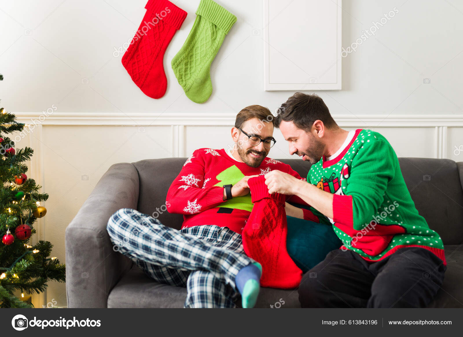 Attractive Caucasian Gay Couple Pajamas Opening Gifts Christmas Stockings Looking Stock Photo tonodiaz 613843196