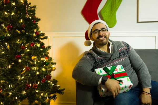 Handsome Cheerful Man Wearing Santa Hat Sitting Next Christmas Tree — Stock Photo, Image