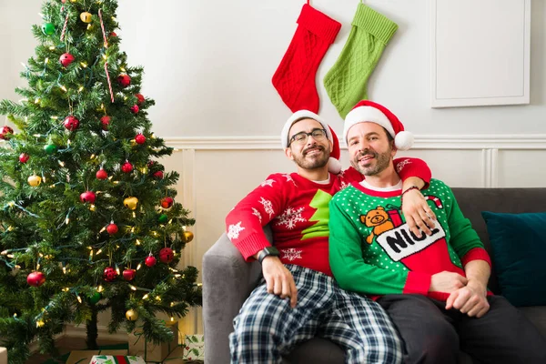 Portrait Happy Gay Couple Hugging Relaxing Christmas Morning Opening Presents — Stock Photo, Image