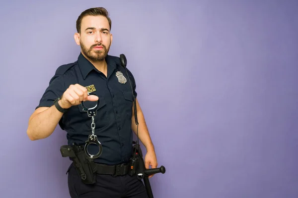 Overstuur Politieagent Kijkt Boos Terwijl Het Houden Van Handboeien Aan — Stockfoto