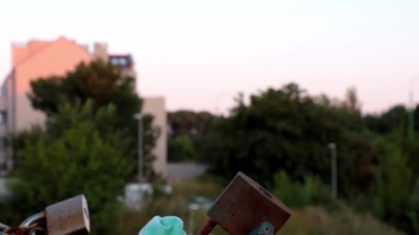 Poznan, Poland, June 24, 2021: a medical mask tied to the lock of the bridge. — Stock Video