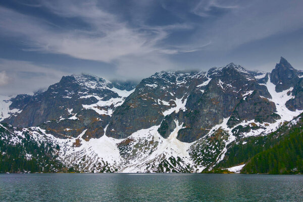 Picturesque view of the lake and mountains with snow