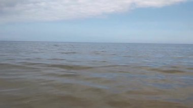 View of the blue water of the sea or ocean against the blue sky. Rest on the sea