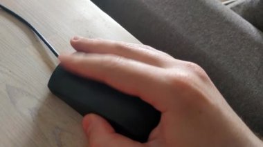 Top view of a person's hand with a computer mouse. Work at the computer in the office or at home