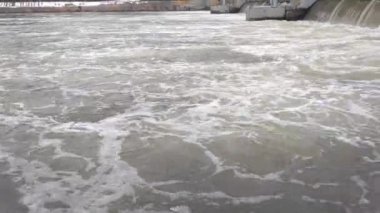 Large flow of water on the river. Cold and dirty water. Water and environment pollution