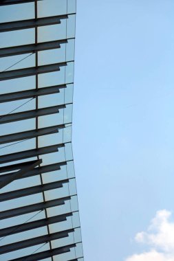 Metal construction with glass against the background of a blue sky