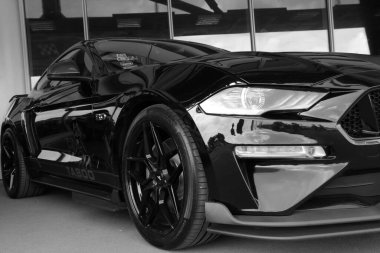 Wroclaw, Poland, August 22, 2021: Black and white photo. Powerful black modern Ford Mustang