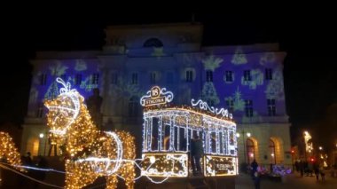 Warsaw, Poland, December 14, 2021: Christmas and New Year illumination. Children and adults are preparing for the holiday. Relax in the main square. Christmas mood, entertainment