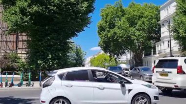 London, United Kingdom, June 28, 2022: city traffic on a sunny day in a small building in London