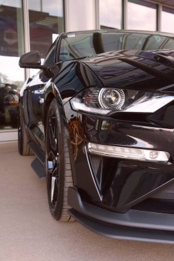 Wroclaw, Poland, August 22, 2021: beautiful and powerful modern Ford Mustang. Front view of the car. Black Ford