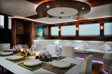 Lounge and dinner room of luxury yacht clipart