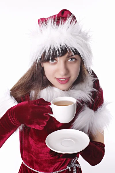 Weihnachtsmann-Mädchen trinkt Tee — Stockfoto