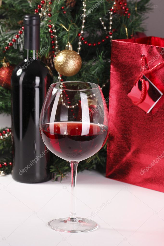 Red wine, christmas tree and bag with gift