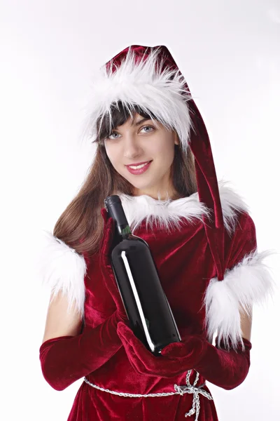 Santa girl shows a bottle of red wine — Stock Photo, Image