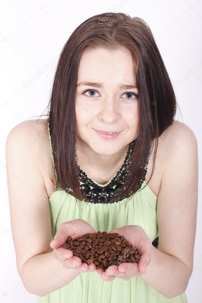 Young girl holding a coffee beans