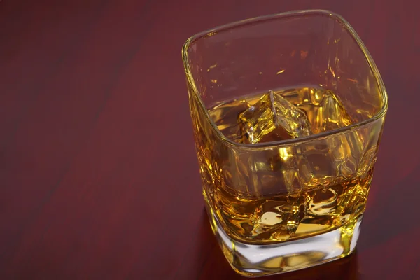 Glass of whisky with ice cubes — Stock Photo, Image