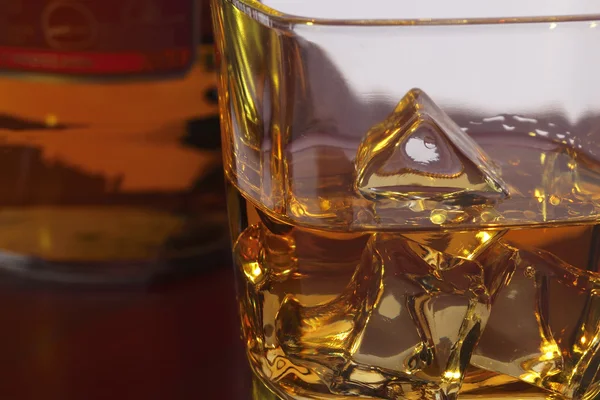 Glass of whisky with ice — Stock Photo, Image