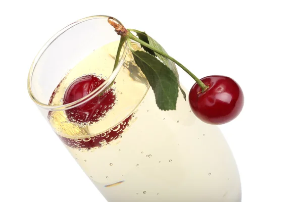 Cherries into a glass with champagne — Stock Photo, Image