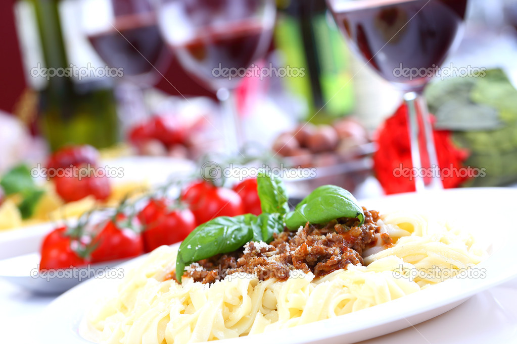 pasta bolognese with basil and cheese