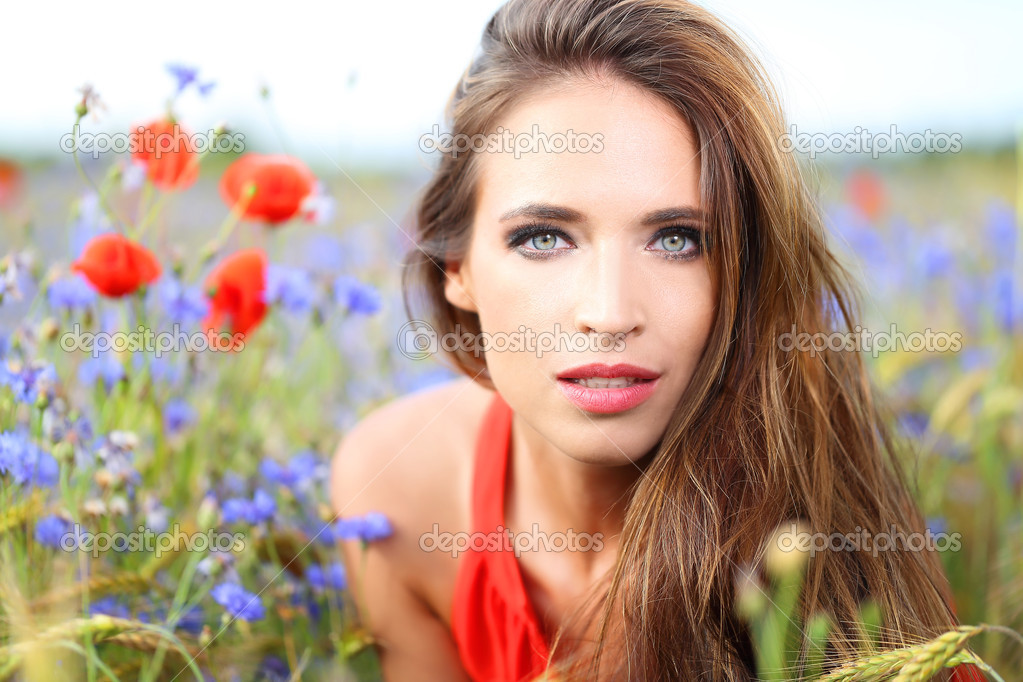 Cute woman on flower field