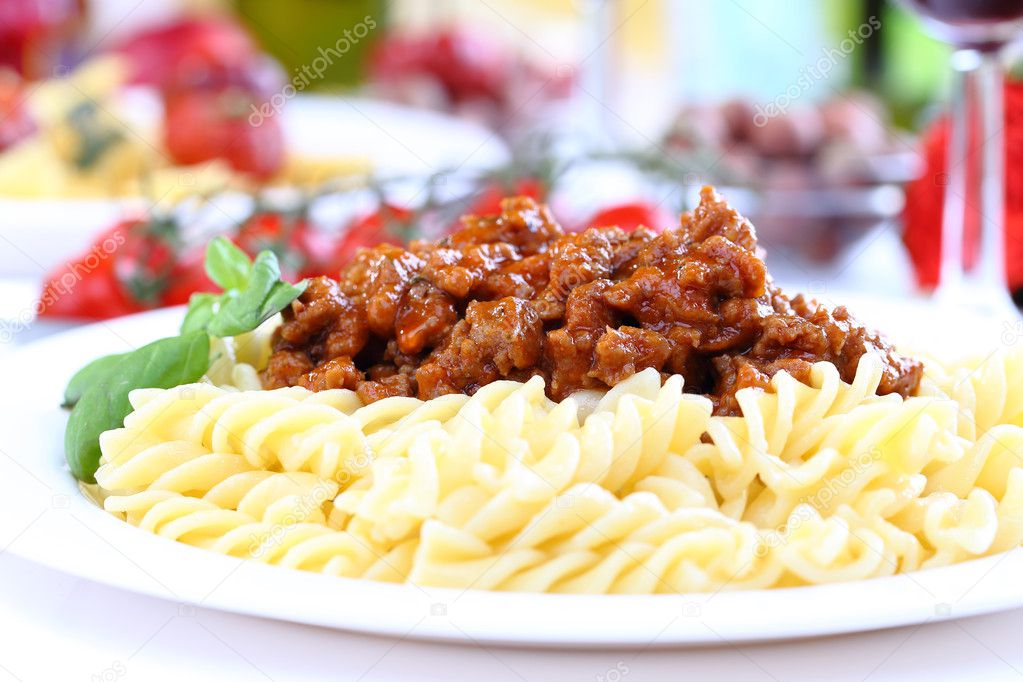Pasta bolognese with basil and cheese