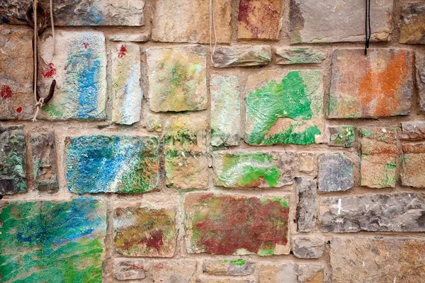 Stone wall with colorful spots — Stock Photo, Image