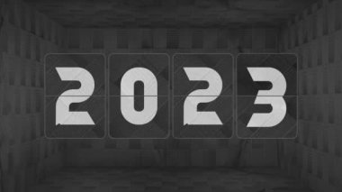 Flip clock switches from year 2022 to 2023, all the way to 2029. Dark Checkered black space box. Mechanical flip clock switches from year 2022 to 2023, 2024, 2025, 2026, 2027, 2028 to 2029 in a dark space, box. Vintage flip calendar. Happy New Year!