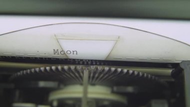Moon Landing has been faked. Conspiracy theory. Electric typewriter typing on white paper. Electronic modern vintage typewriter typing words sentences on a white sheet of paper. Typescript, carriage.