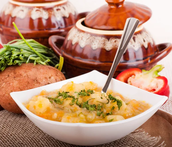 Potato with meat and mushrooms in a pot home-style — Stock Photo, Image