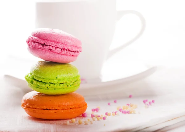 Multi-colored cakes and coffee on a white napkin — Stock Photo, Image