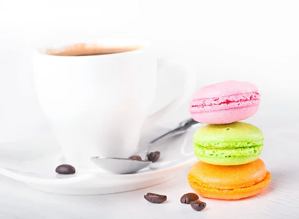 Multi-colored cakes and coffee on a white napkin — Stock Photo, Image