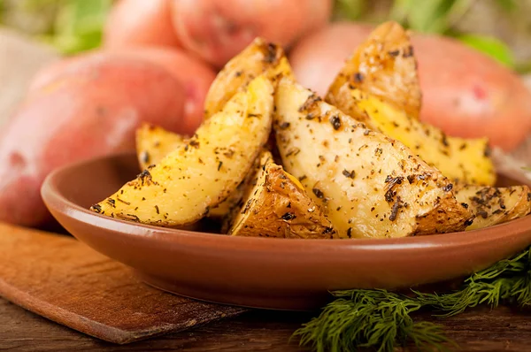 Potatoes baked in an oven with spices — Stock Photo, Image