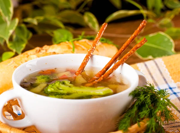 Vegetable soup with salty straws and raw smoked sausage — Stock Photo, Image