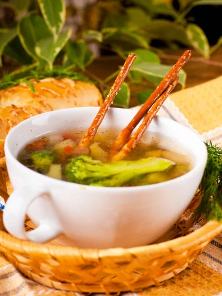 Vegetable soup with salty straws and raw smoked sausage — Stock Photo, Image