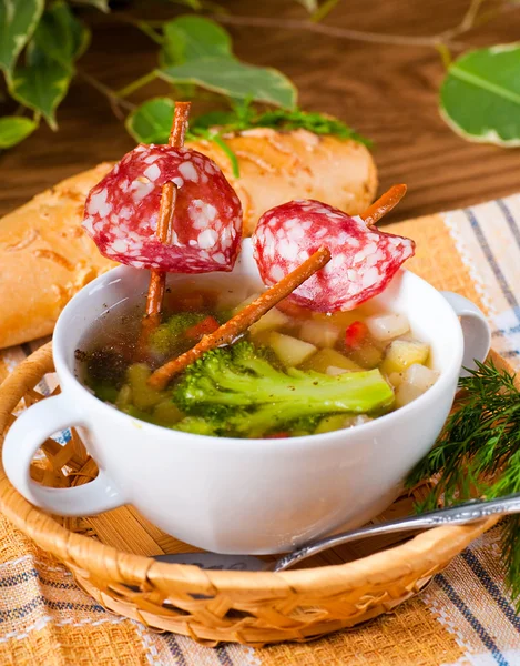 Vegetable soup with salty straws and raw smoked sausage — Stock Photo, Image