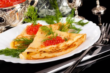 Gümüş eşya üzerinde kırmızı havyar ile Pancakes