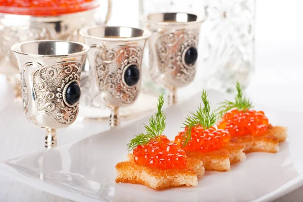 Pancakes with red caviar on silver ware — Stock Photo, Image