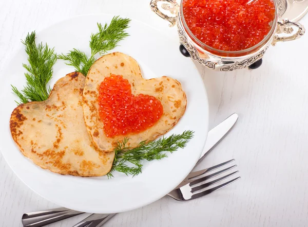 Pancakes with red caviar on silver ware — Stock Photo, Image