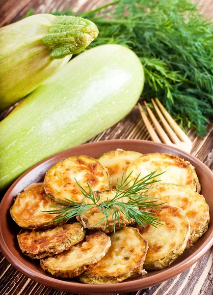 Green zucchini pancakes on a wooden old board — Stock Photo, Image