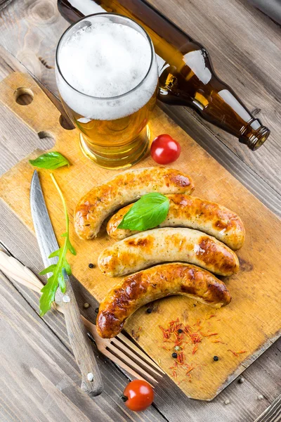 The Munich sausages with tomatoes and arugula — Stock Photo, Image