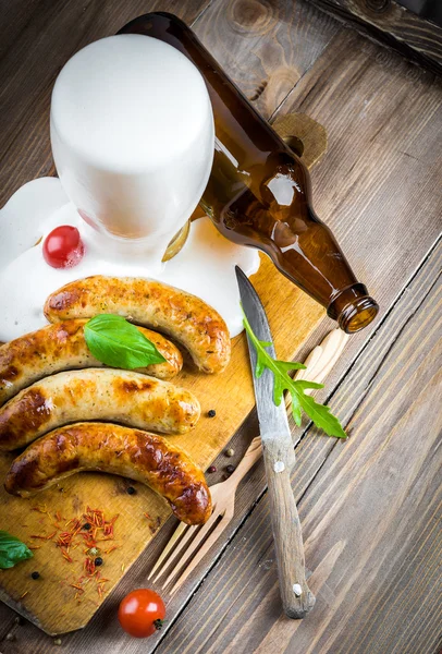 The Munich sausages with tomatoes and arugula — Stock Photo, Image