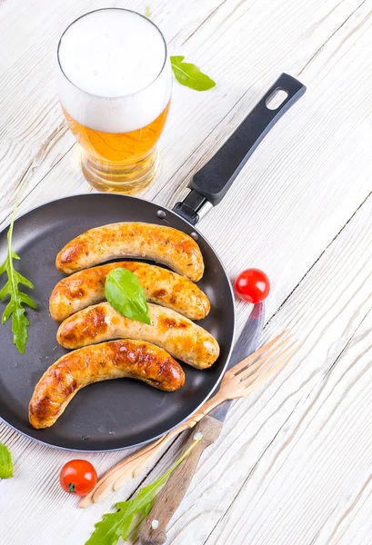 The Munich sausages with tomatoes and arugula — Stock Photo, Image
