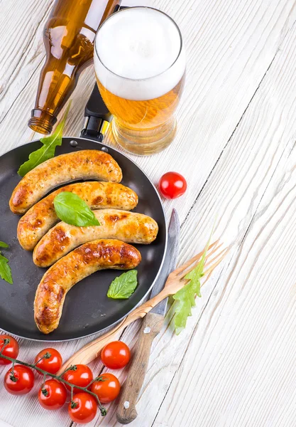 The Munich sausages with tomatoes and arugula — Stock Photo, Image