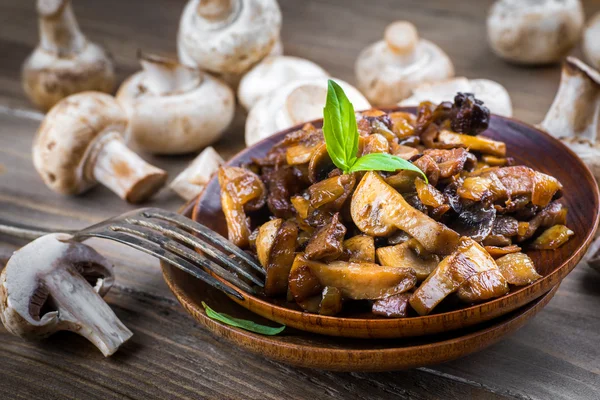 Raw and cooked champignons Stock Image