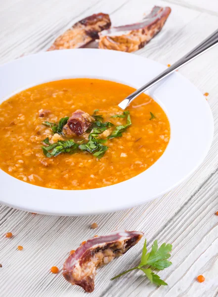 Bowl of soup with a spoon inside — Stock Photo, Image