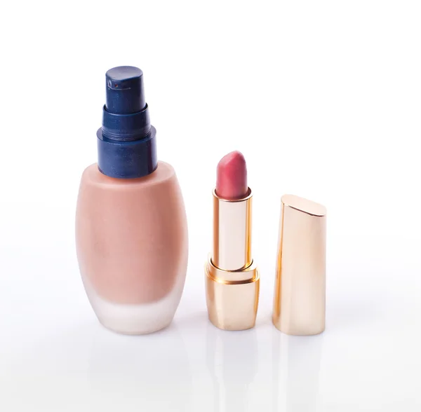 Cosmetic liquid foundation and pink lipstick isolated on white b — Stock Photo, Image