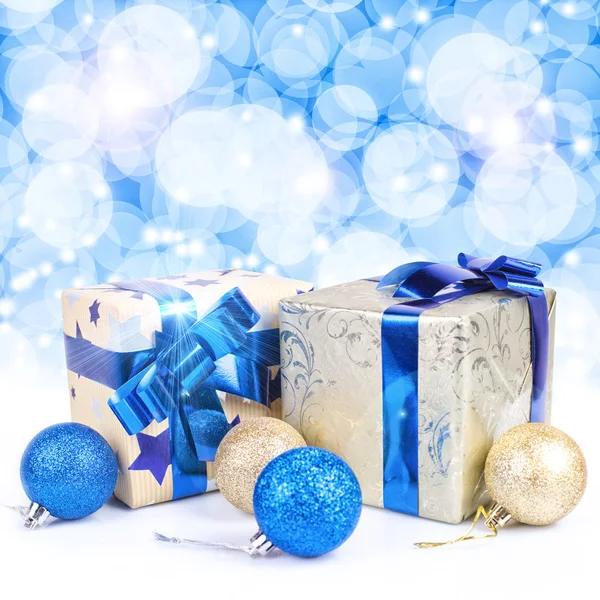 Gift boxes against glowing background — Stock Photo, Image