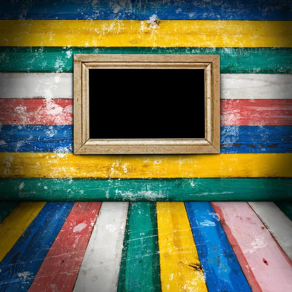 Empty frame on colorful wooden room — Stock Photo, Image